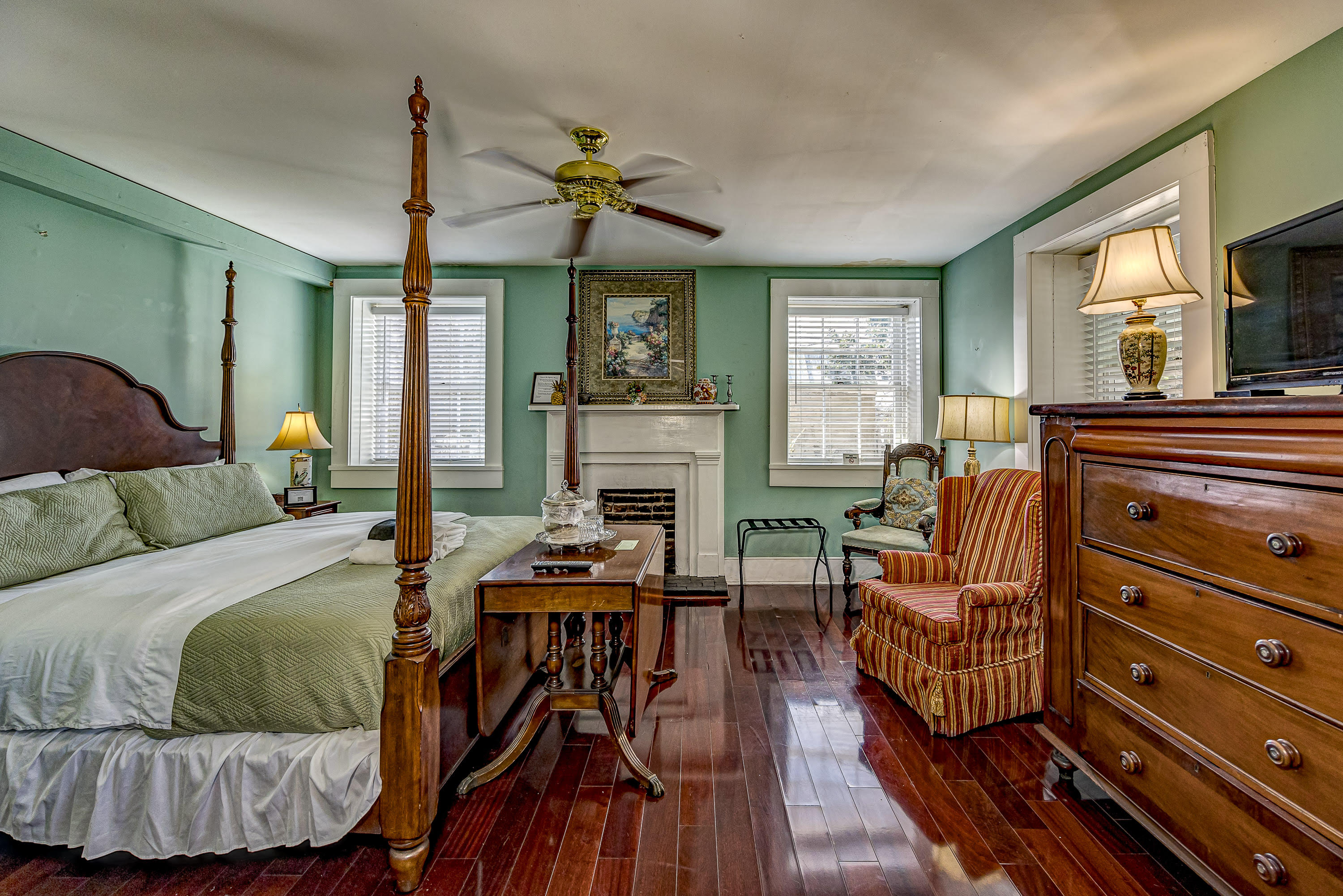 Large king bed, fireplace, two wing chairs, door to bath, hardwood floors