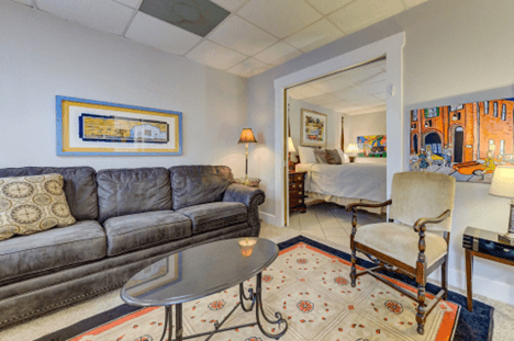 couch, oriental rug, chair, art, cased opening to bedroom