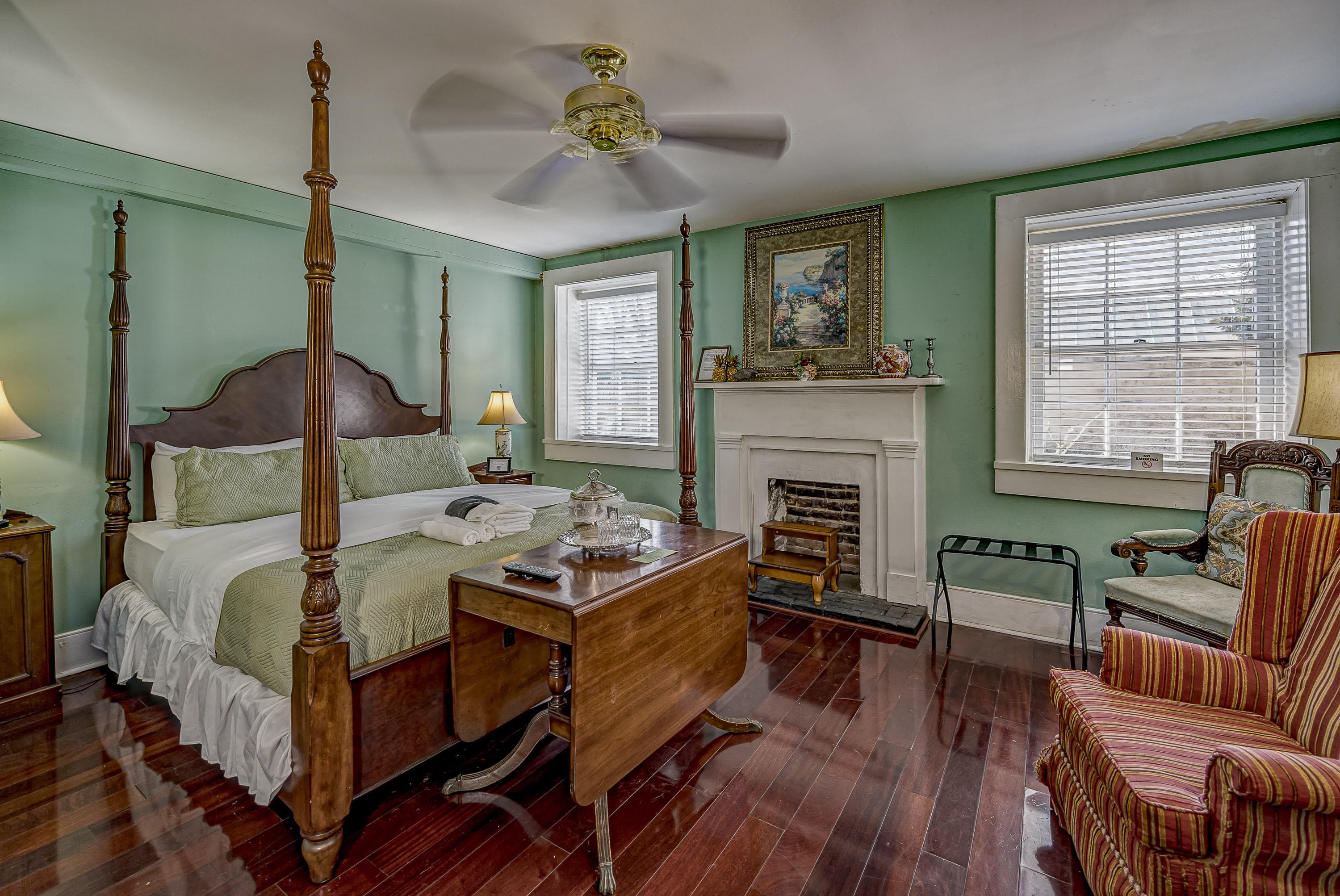two wing chairs, television on mantle