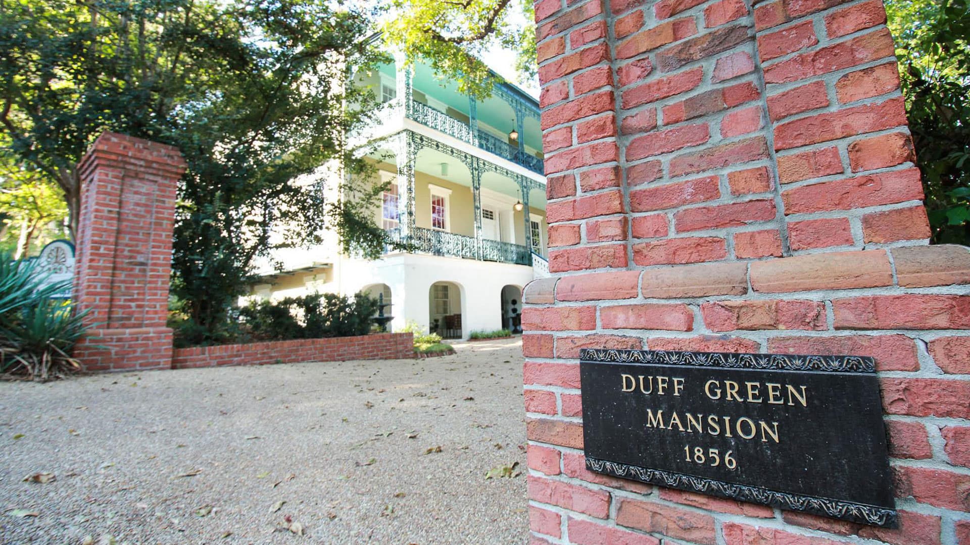 Brick entrance with a sign for the Duff Green Mansion, built in 1856, partially visible in the background.